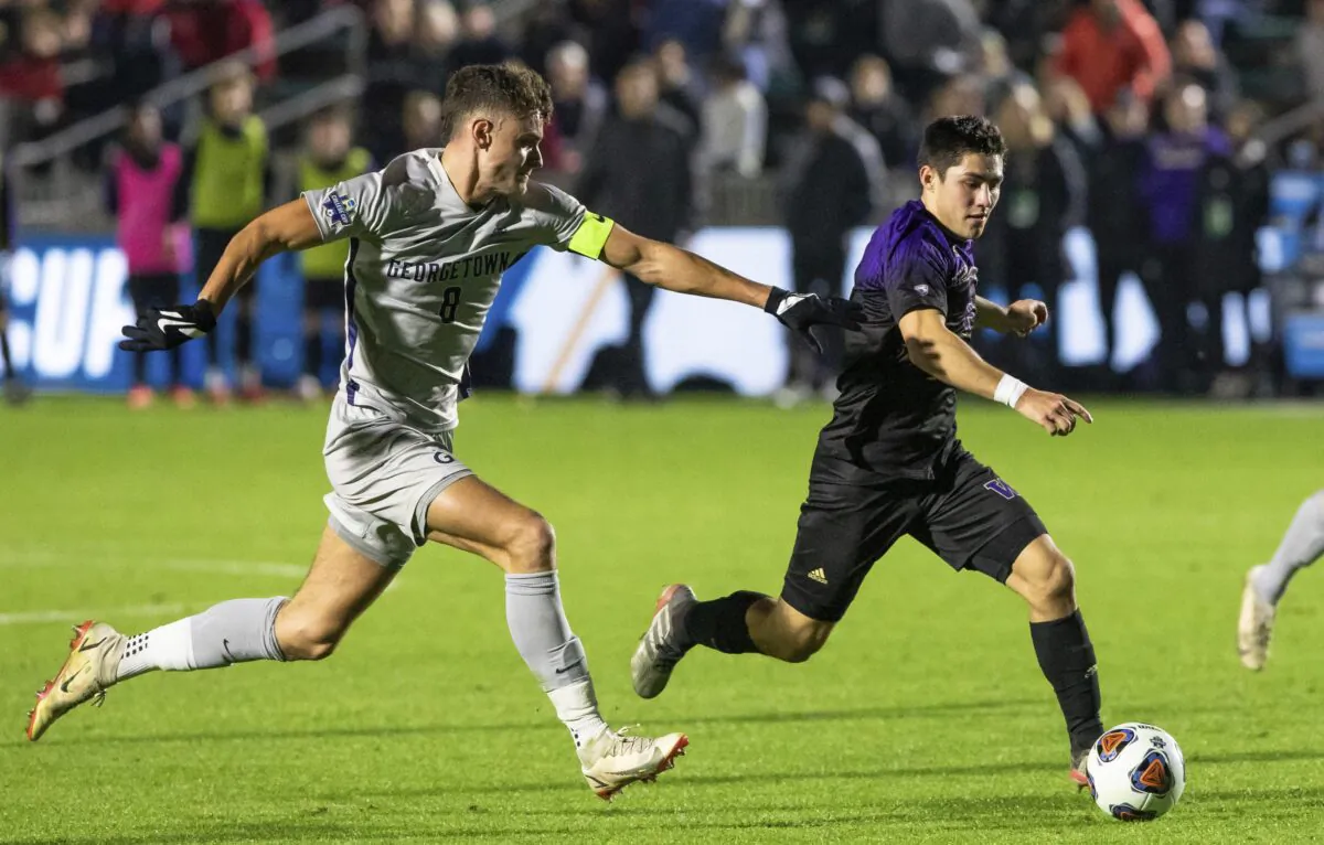 Washington's Kalani Kossa-Rienzi (R) moves the ball as Georgetown's Dante Polvara defends during a soccer game in Cary, N.C., on Dec. 10, 2021. (Ben McKeown/AP Photo)