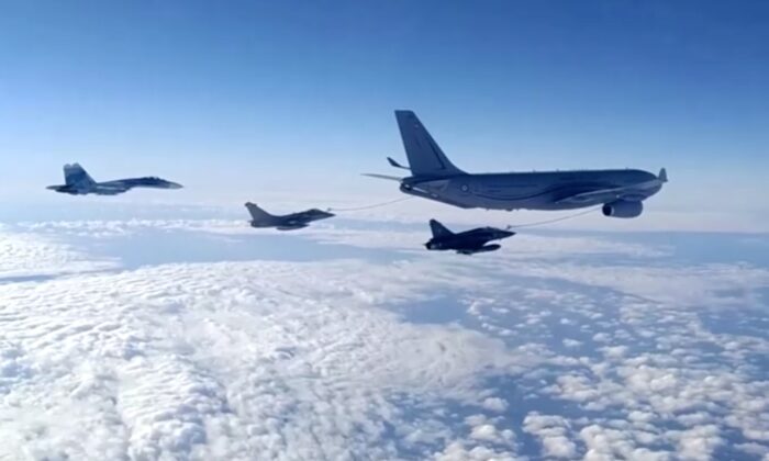 Three Russian fighter jets escort a NATO military aircraft  over Black Sea on Dec. 9, 2021. (Courtesy of Russian Defence Ministry)