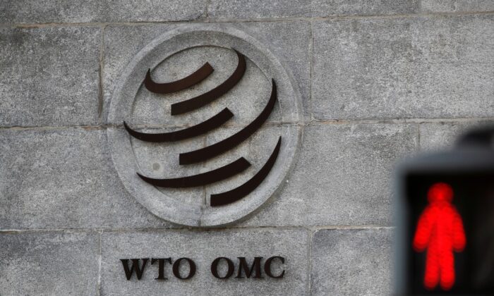 A logo is pictured outside the World Trade Organization (WTO) headquarters next to a red traffic light in Geneva, Switzerland on Oct. 2, 2018. (Reuters/Denis Balibouse/File Photo)