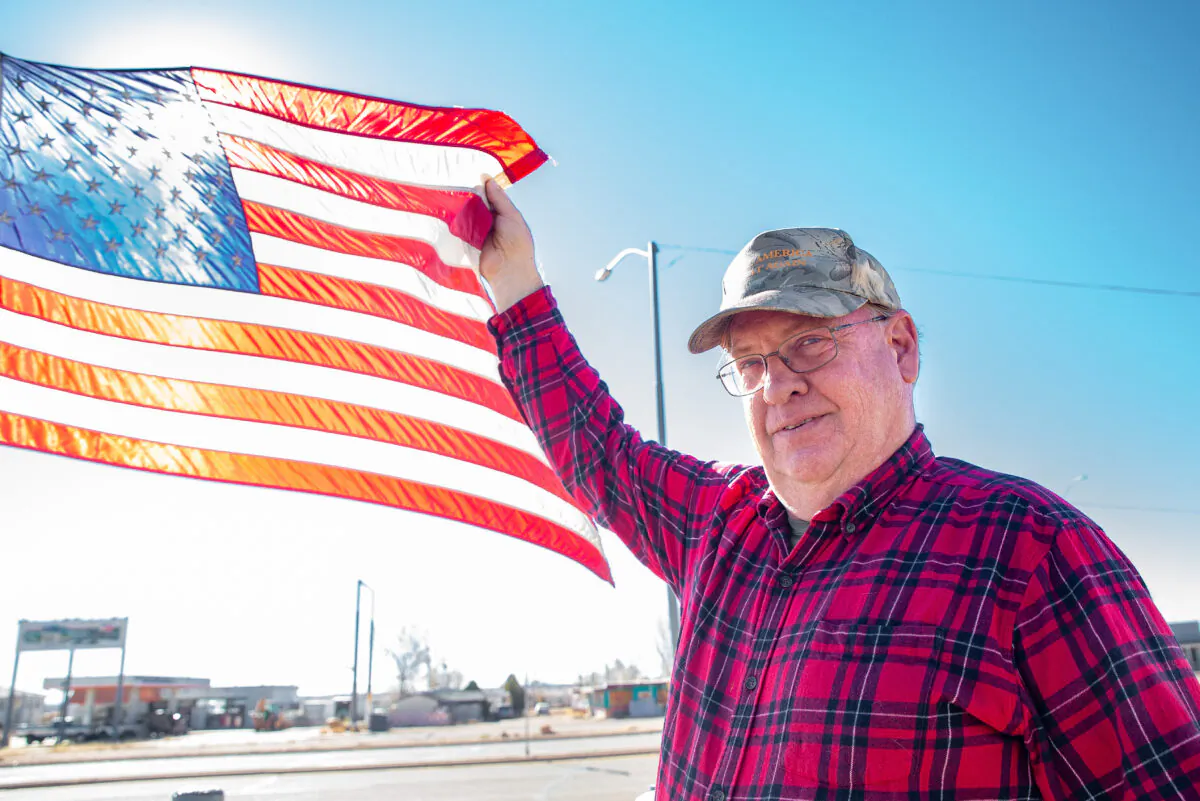Resident Richard Frei holds an American Flag in Winslow, Ariz., on Dec. 4, 2021. (John Fredricks/The Epoch Times)