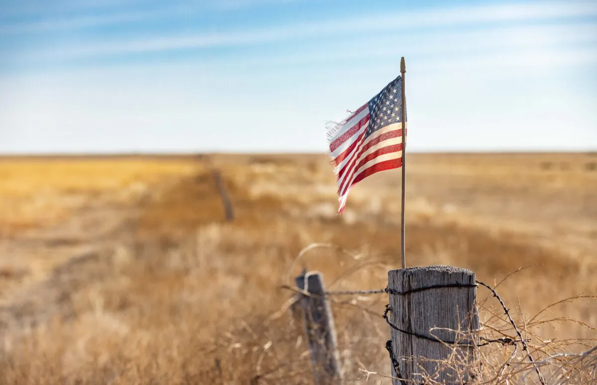 An American flag waves at the edge of a farm outside Walsh, Colorado, on Dec. 6, 2021. (John Fredricks/The Epoch Times)