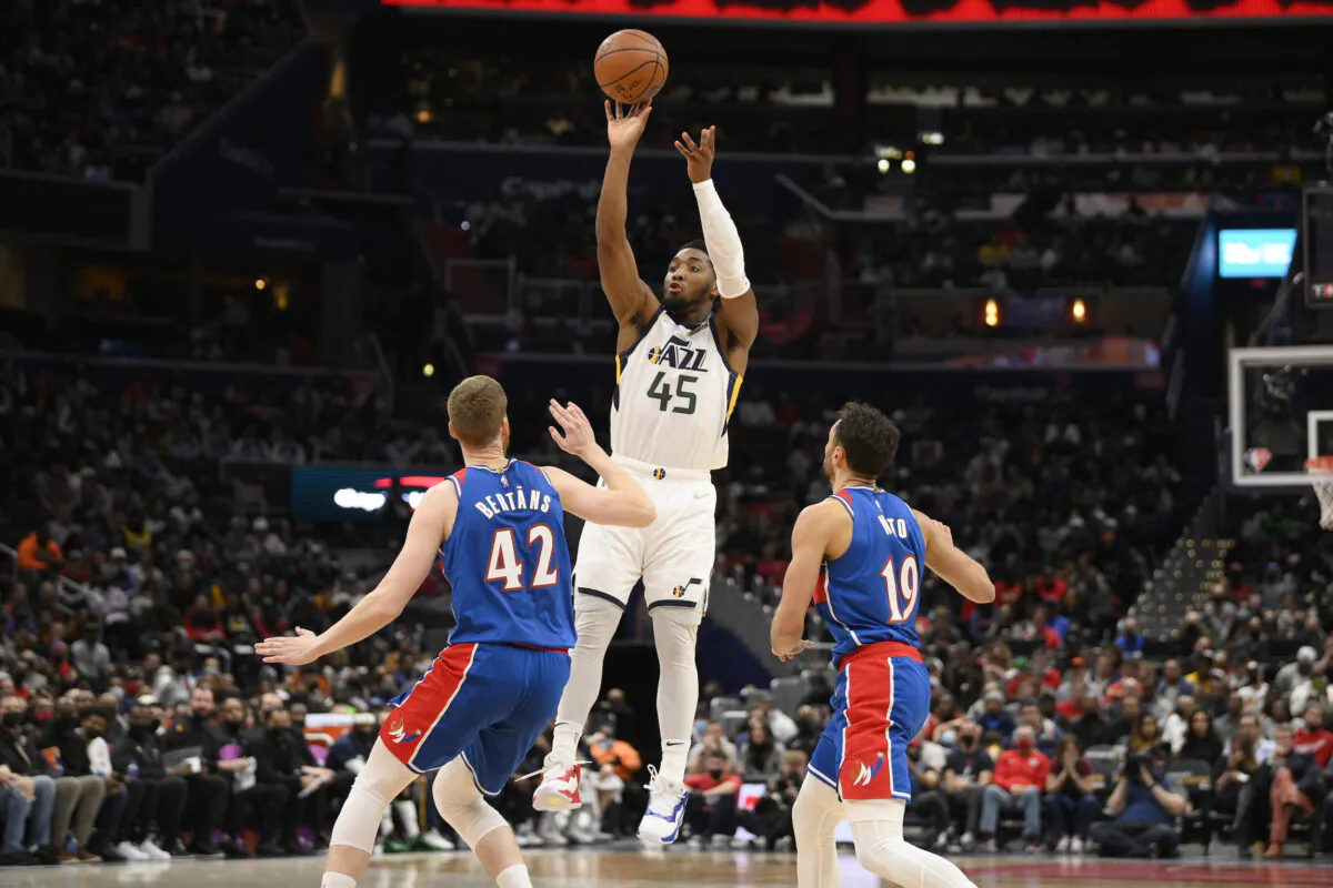 Utah Jazz guard Donovan Mitchell (45) shoots against Washington Wizards forward Davis Bertans (42) and guard Raul Neto (19) during the first half of an NBA basketball game, in Washington on Dec. 11, 2021. (Nick Wass/AP Photo)