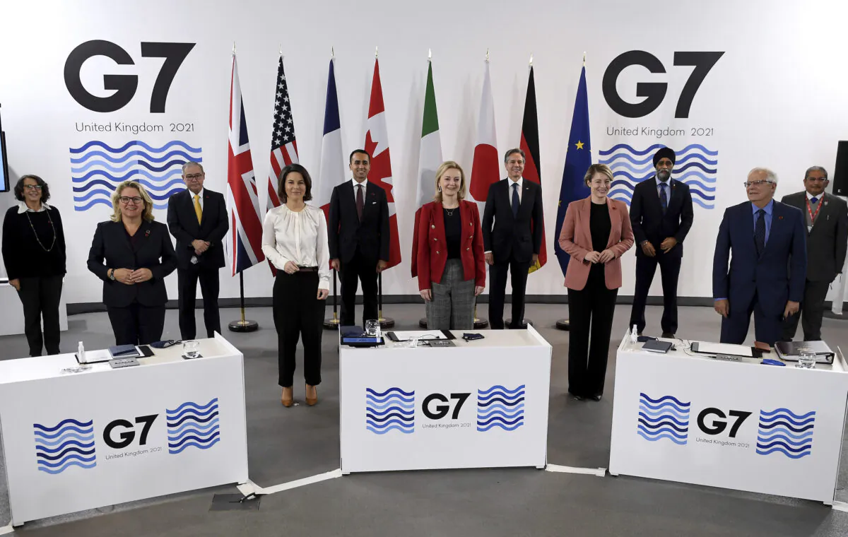 G7 Foreign and Development Ministers pose for a group photo in Liverpool, England, on Dec. 12, 2021. Foreign Secretary Liz Truss is hosting U.S. Secretary of State Antony Blinken and other Group of Seven counterparts for weekend talks in the northwest England port city of Liverpool as the wealthy nations club faces growing tensions with Russia, China, and Iran. (Olivier Douliery/Pool via AP)