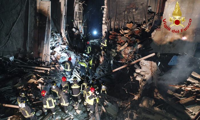 Italian firefighters and rescuers search for survivors among the rubble of a collapsed building, in Ravanusa, Sicily, Italy, on Dec. 12, 2021. (Italian Firefighters Vigili del Fuoco via AP)