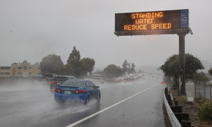 Cars drive by a sign on Highway 101 in Corte Madera, Calif., on Oct. 24, 2021. (Justin Sullivan/Getty Images)