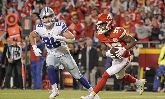 Kansas City Chiefs cornerback L'Jarius Sneed (38) is chased by Dallas Cowboys tight end Dalton Schultz (86) after catching an interception late in the second half of an NFL football game in Kansas City, Mo., on Nov. 21, 2021. (Charlie Riedel/AP Photo)