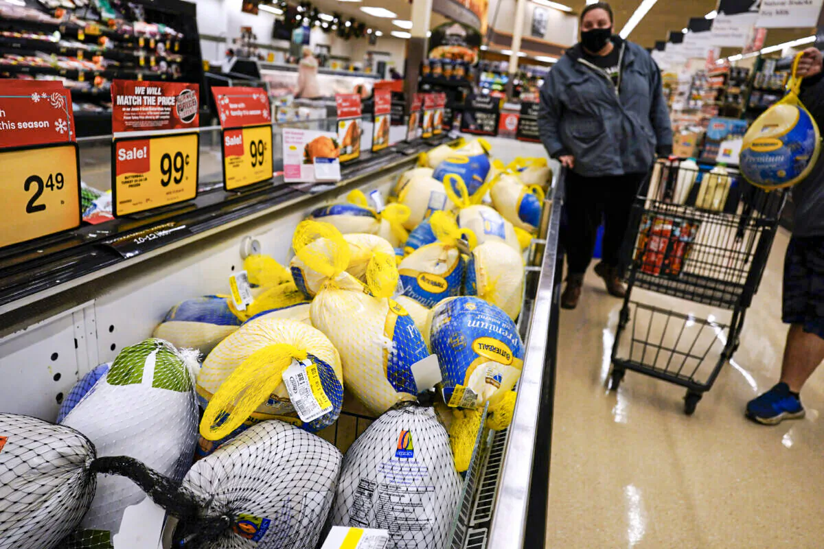 People shop for frozen turkeys at a grocery store in Mount Prospect, Ill., on Nov. 17, 2021. (Nam Y. Huh/AP Photo)
