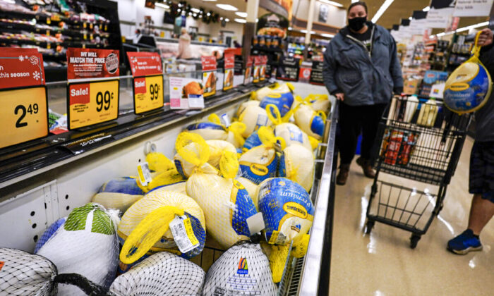 People shop for frozen turkeys at a grocery store in Mount Prospect, Ill., on Nov. 17, 2021. (Nam Y. Huh/AP Photo)