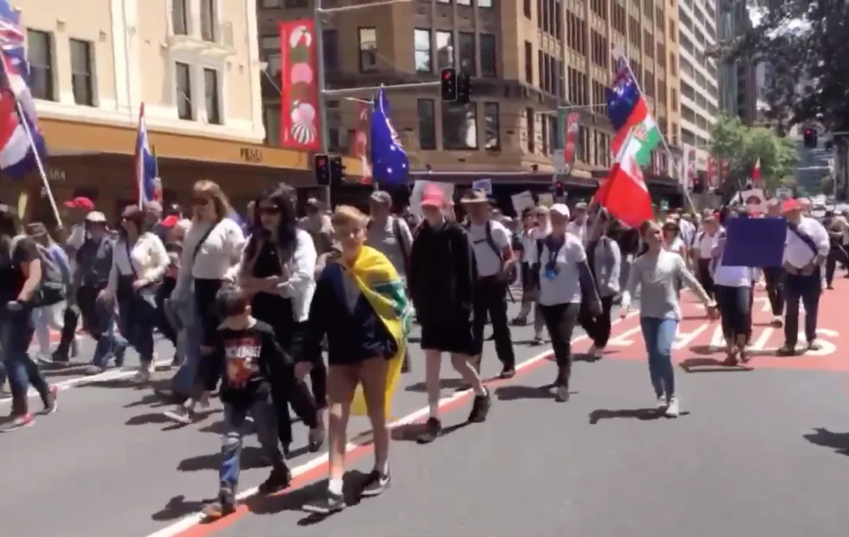 Thousands of protesters marched through the city against COVID-19 mandates in Sydney, Australia, on Dec. 12, 2021. (Screenshot/Epoch Times staff)