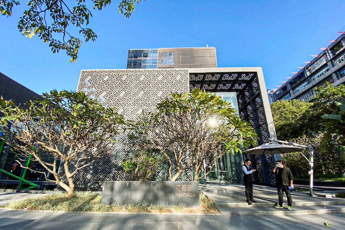 Men stand outside the headquarters of Chinese developer Fantasia Holdings in Shenzhen, Guangdong province, China, on Nov. 10, 2021. (David Kirton/Reuters)