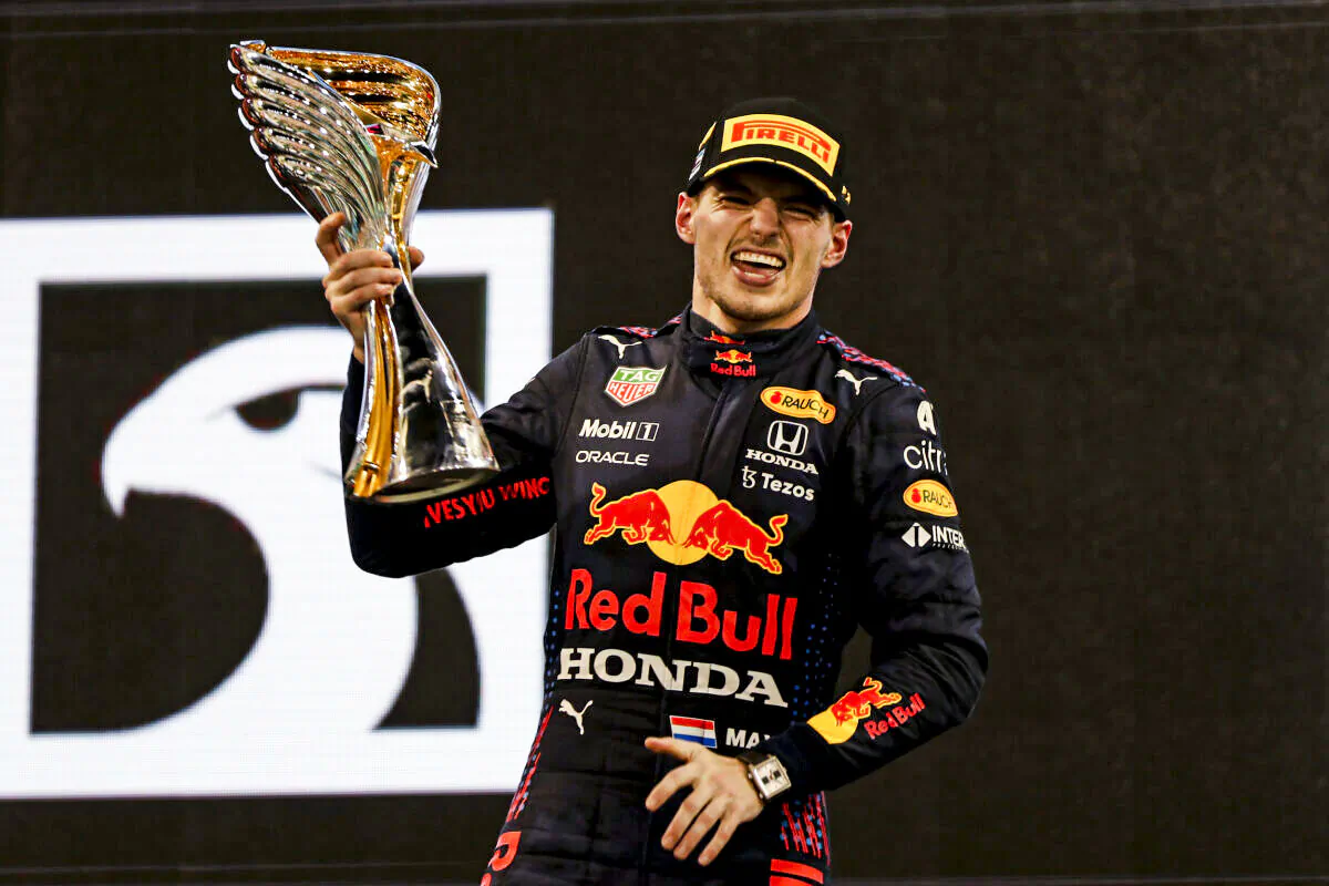 Red Bull driver Max Verstappen of the Netherlands celebrates on the podium after becoming F1 drivers world champion after winning the Formula One Abu Dhabi Grand Prix in Abu Dhabi, United Arab Emirates, on Dec. 12. 2021. (Kamran Jebreili/AP Photo)