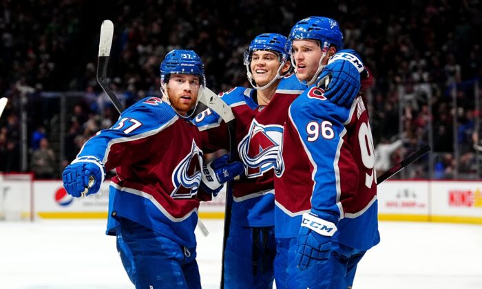 Colorado Avalanche left wing Andre Burakovsky (95) celebrates his goal with teammates left wing J.T. Compher (37) and right wing Mikko Rantanen (96) in the second period against the Florida Panthers at Ball Arena in Denver, on Dec 12, 2021. (Ron Chenoy/USA TODAY Sports via Field Level Media)