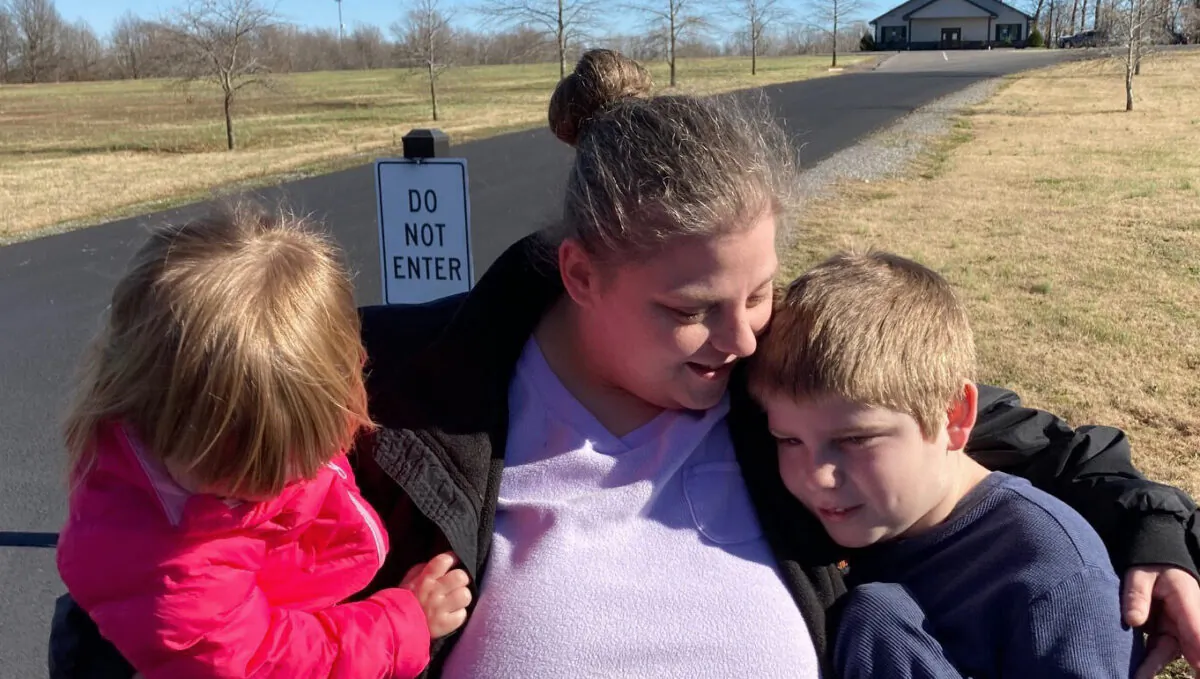 Autumn Kirks comforts her children in Mayfield, Ky., on Dec. 12, 2021.  (Bruce Schreiner/AP Photo)