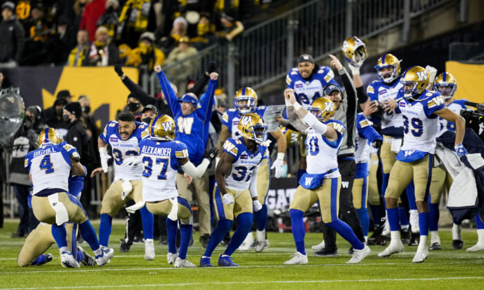 The Winnipeg Blue Bombers celebrate their victory against the Hamilton Tiger-Cats in the 108th CFL Grey Cup in Hamilton on Dec. 12, 2021. (The Canadian Press/Ryan Remiorz)