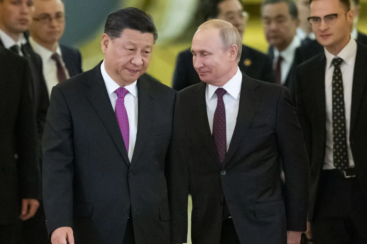 Chinese leader Xi Jinping and Russian President Vladimir Putin walk toward a hall in the Kremlin to hold talks, in Moscow on June 5, 2019. (AP Photo/Alexander Zemlianichenko, Pool, File)