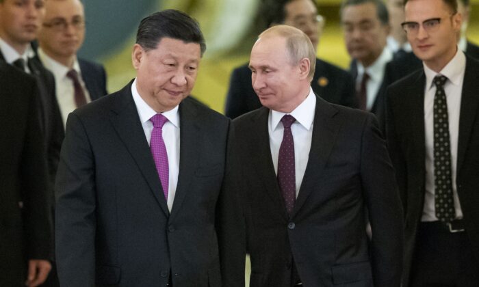 Chinese leader Xi Jinping and Russian President Vladimir Putin walk toward a hall in the Kremlin to hold talks, in Moscow on June 5, 2019. (Alexander Zemlianichenko, Pool, File/AP Photo)
