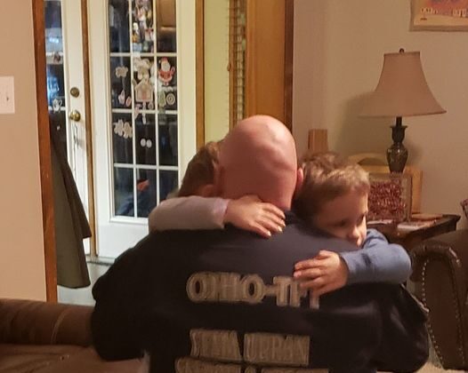 Ohio Task Force member Chris Heaton received hugs from his twins Kennedy (L) and Elias (R) before he left Dec. 12 to help tornado victims in southwestern Kentucky. Heaton is part of a rescue and recovery team that will look through damaged properties in Graves County. (Mandy Heaton)