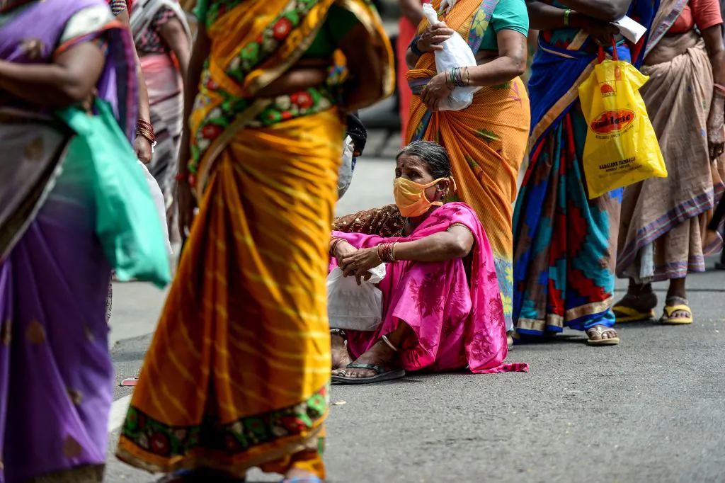 Women queue outside a post office to collect aid provided by the Telangana state government during a government-imposed nationwide lockdown in Secunderabad, India, on May 6, 2020. (Noah Seelam/AFP via Getty Images)