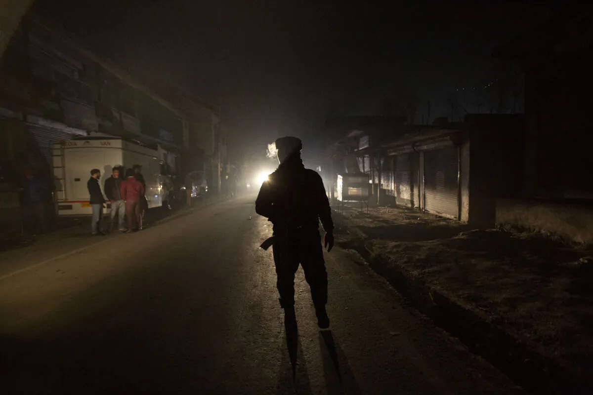 An Indian soldier guards near the site of an attack on the outskirts of Srinagar, Indian controlled Kashmir, on Dec. 13, 2021. (Mukhtar Khan/AP Photo)