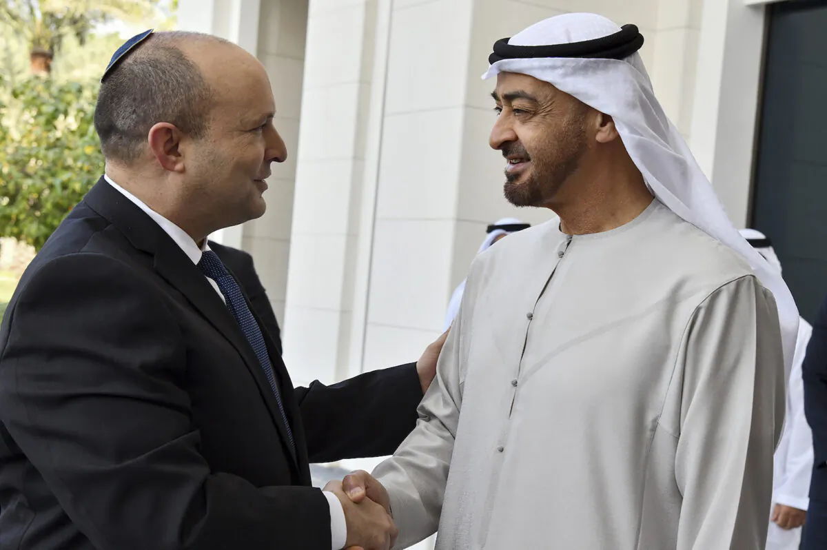 Israeli Prime Minister Naftali Bennett, left, received by Abu Dhabi Crown Prince Sheikh Mohammed bin Zayed at his private palace in Abu Dhabi, on Dec. 13, 2021. (Haim Zach/Israel Government Press Office via AP)
