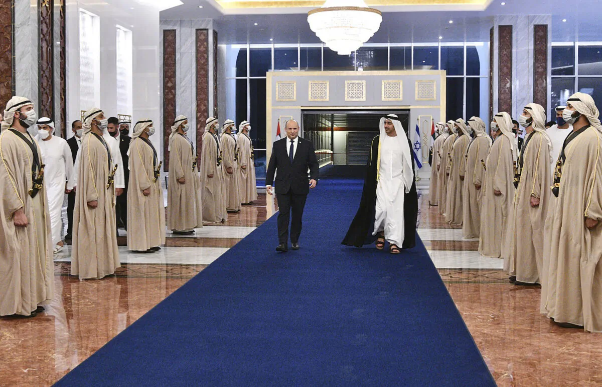 Israeli Prime Minister Naftali Bennett (L), received by an honor guard and the UAE Foreign Minister, Sheikh Abdullah bin Zayed Al Nahyan, in Abu Dhabi, UAE, on Dec. 12, 2021. (Haim Zach/Israel Government Press Office via AP)