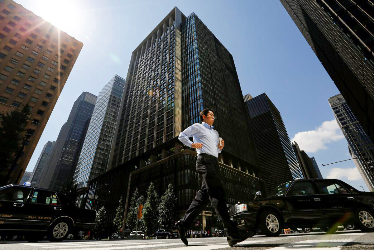 A man runs on a crosswalk at a business district in central Tokyo, Japan, on Sept. 29, 2017. (Toru Hanai/Reuters)