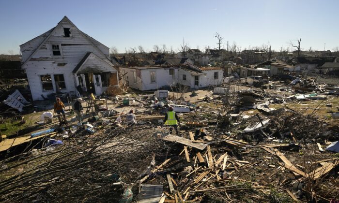 Volunteers help Martha Thomas (2nd L) salvage possessions from her destroyed home, in the aftermath of tornadoes that tore through the region, in Mayfield, Ky., on Dec. 13, 2021. (Gerald Herbert/AP Photo)