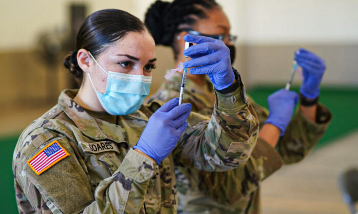 Spc. Kailee Soares prepares a dose of the COVID-19 vaccine during a drive to vaccinate Hawaii National Guardsmen assigned to the COVID-19 task force response on Kauai Island, Jan. 12, 2021. (U.S. Air National Guard /Master Sgt. Andrew Jackson)