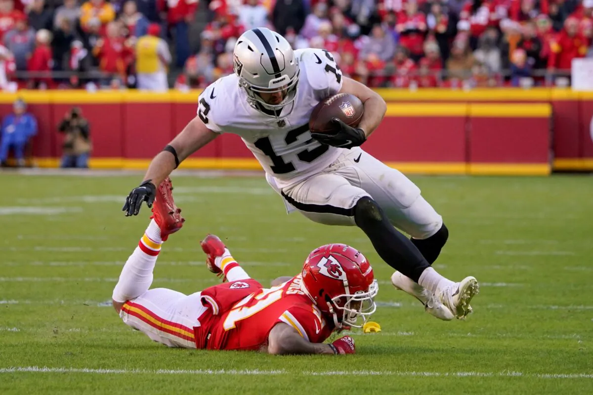 Las Vegas Raiders wide receiver Hunter Renfrow (13) is stopped by Kansas City Chiefs cornerback Mike Hughes (21) defends during the second half of an NFL football game in Kansas City, Mo., on Dec. 12, 2021. (Ed Zurga/AP Photo)