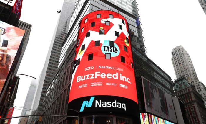 BuzzFeed screens are seen at Times Square during BuzzFeed Inc.'s Listing Day at Nasdaq in New York City on Dec. 06, 2021. (Bennett Raglin/Getty Images for BuzzFeed Inc.)