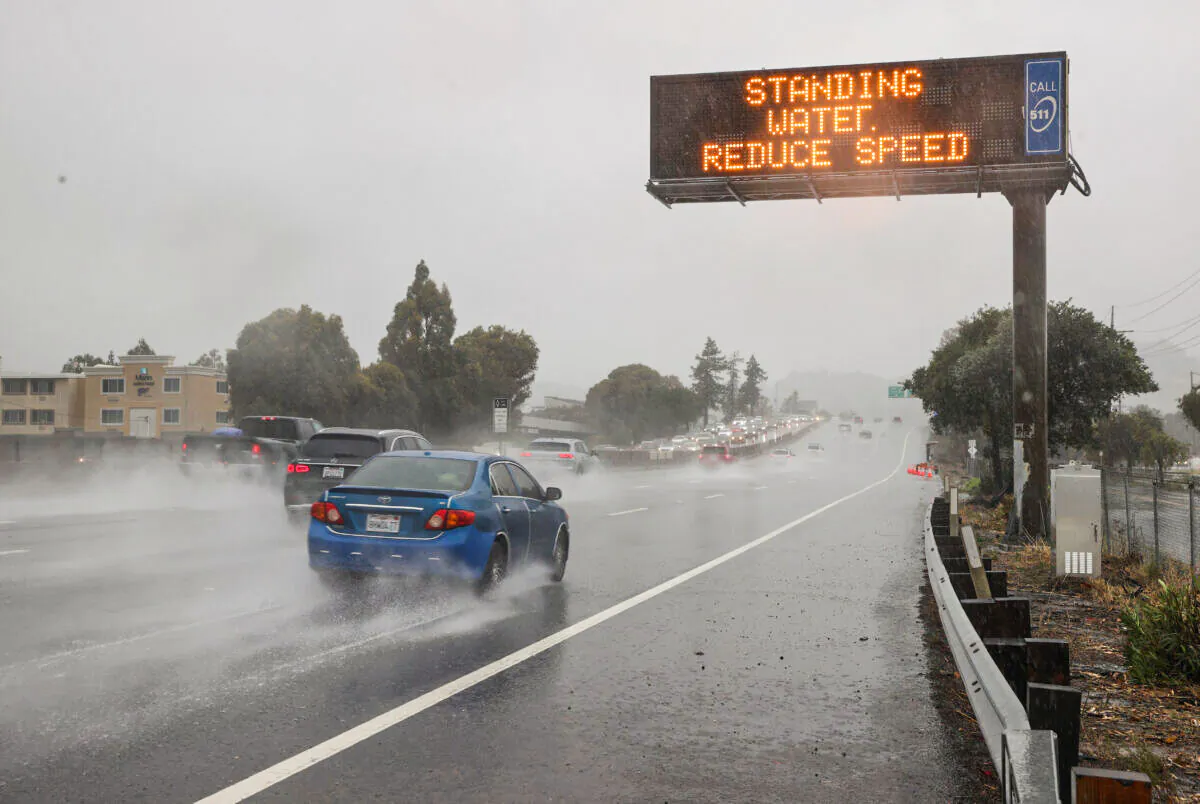 Cars drive by a sign on Highway 101 in Corte Madera, Calif., on Oct. 24, 2021. (Justin Sullivan/Getty Images)