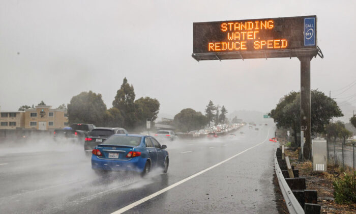 Cars drive by a sign on Highway 101 in Corte Madera, Calif., on Oct. 24, 2021. (Justin Sullivan/Getty Images)