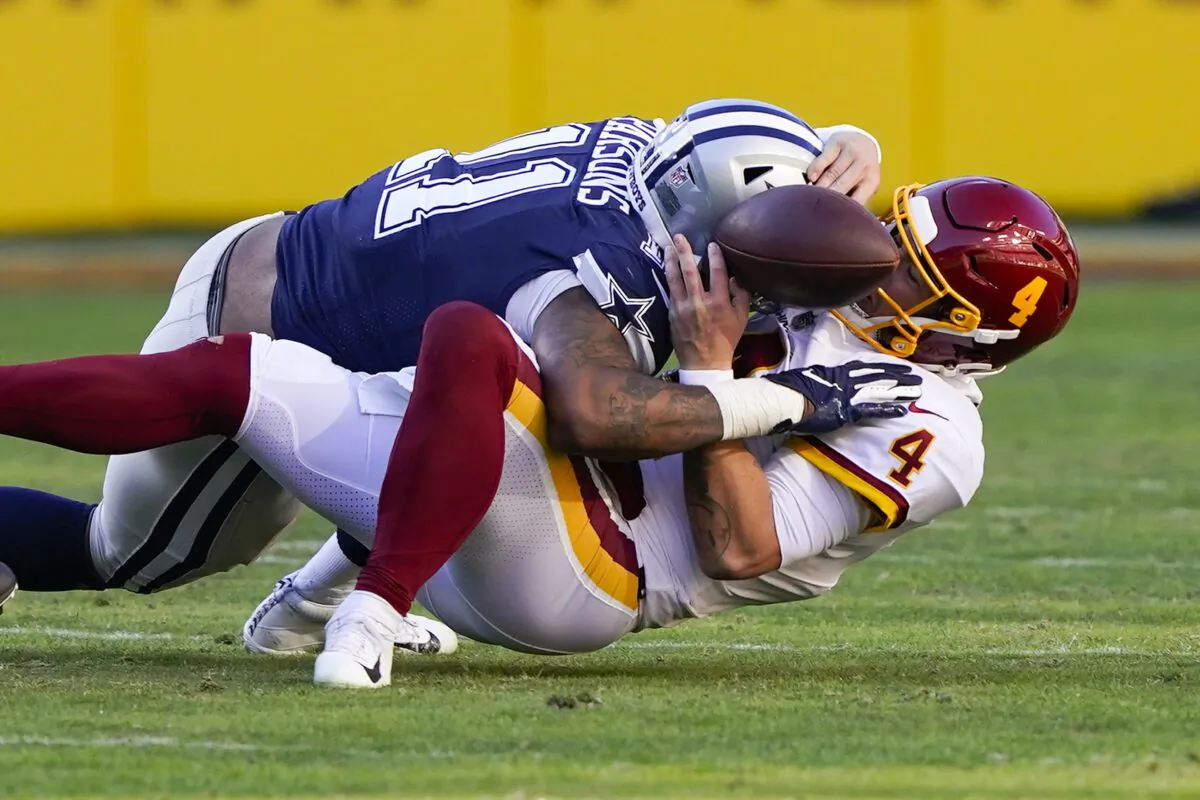 Washington Football Team quarterback Taylor Heinicke (4) fumbles the ball as he is sacked by Dallas Cowboys outside linebacker Micah Parsons (11) during an NFL game in Landover, Md., on Dec. 12, 2021. (Alex Brandon/AP Photo)