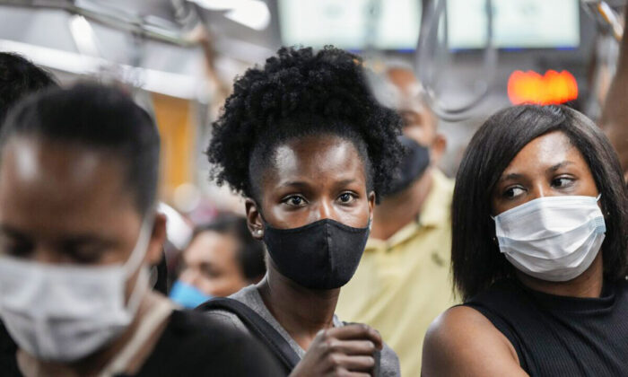 Commuters wear protective face masks as they walk through a subway station, in Sao Paulo, Brazil, on Dec. 1, 2021. (Andre Penner/AP Photo)