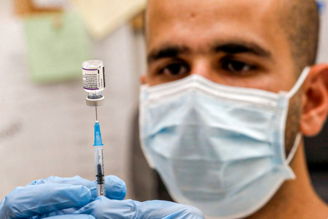 A health care worker in Israel prepares a dose of the Pfizer-BioNTech vaccine in a file photo. (Ahmad Ghababli/AFP via Getty Images)