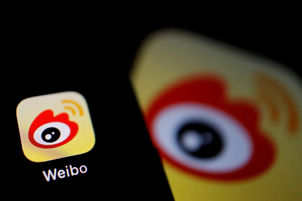 The logo of Chinese social media app Weibo is seen on a mobile phone on Dec. 7, 2021. (Florence Lo/Reuters)