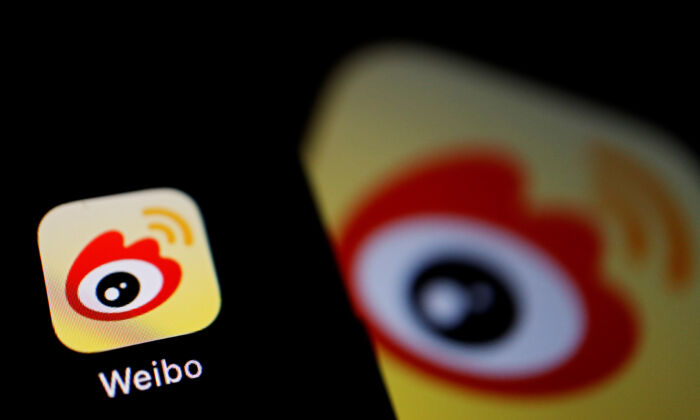 The logo of Chinese social media app Weibo is seen on a mobile phone on Dec. 7, 2021. (Florence Lo/Reuters)