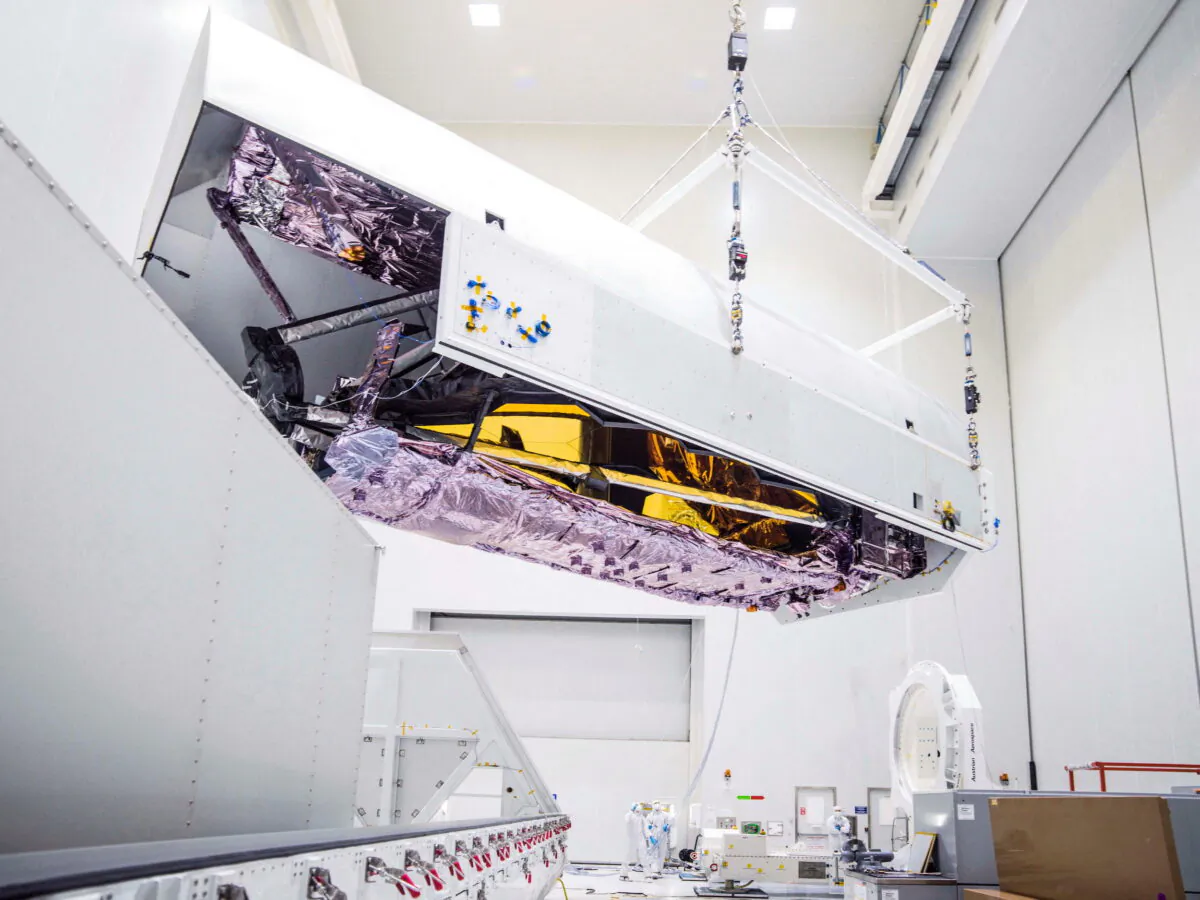 Engineers unpack, clean, and prepare the James Webb Space Telescope ahead of its scheduled launch into orbit, upon its arrival at the launch site in Kourou, French Guiana, as seen in this NASA image released on Nov. 2, 2021 and obtained by Reuters on Dec. 13, 2021. (NASA/Chris Gunn/Handout via Reuters)