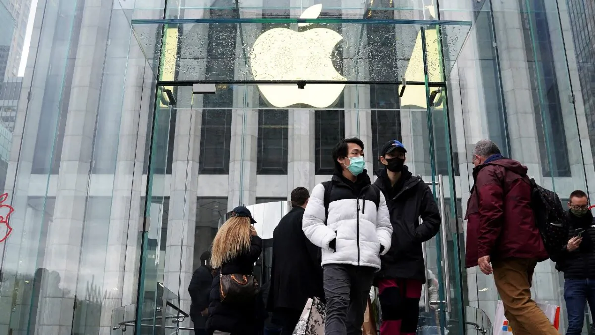 People leave the Apple Store on Fifth Avenue in New York on Nov. 26, 2021. (Carlo Allegri/Reuters)
