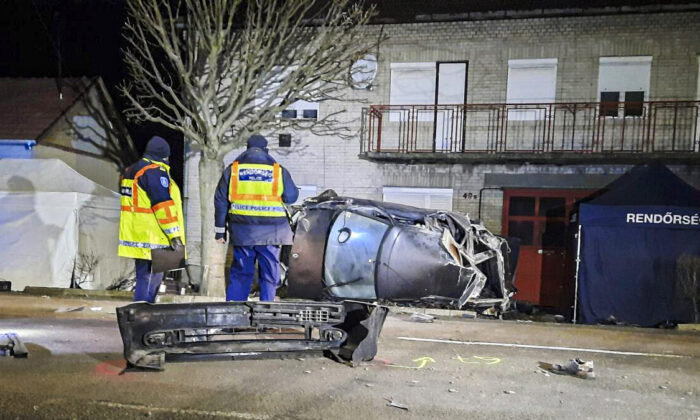 Forensic investigators examine the site of a fatal crash in Morahalom, Hungary, on Dec. 14, 2021. (Hungarian Police via AP)