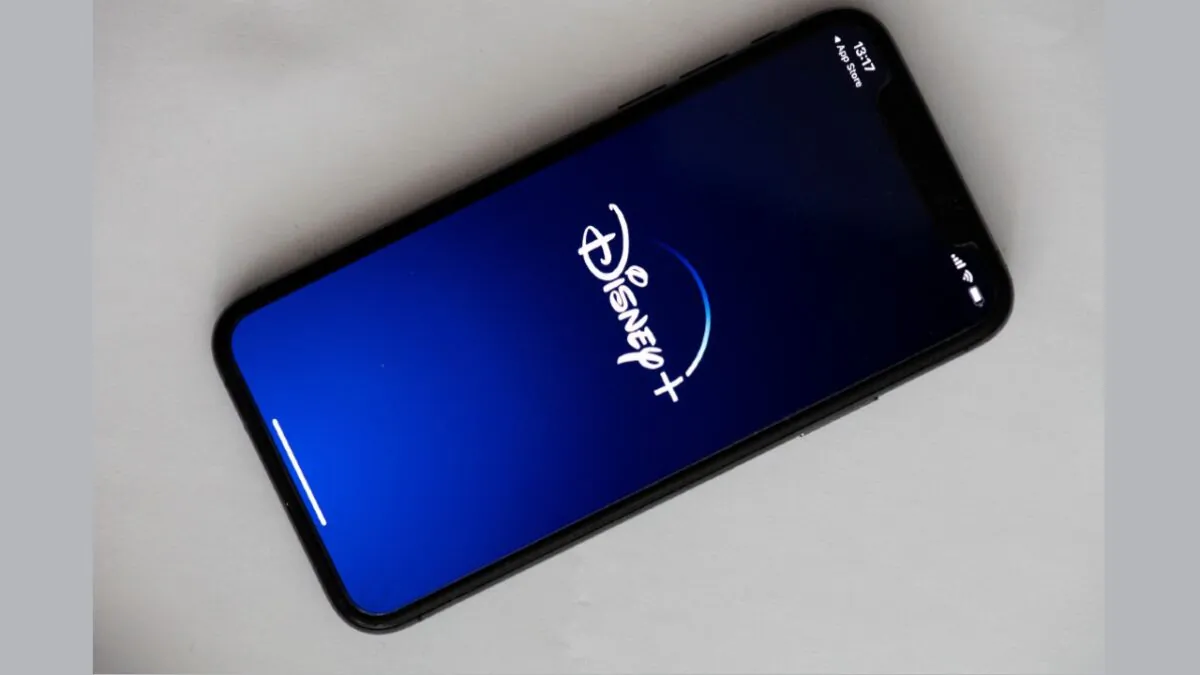 A logo of Disney+ on the screen of a phone in Paris on May 27, 2020. (Martin Bureau/AFP via Getty Images)
