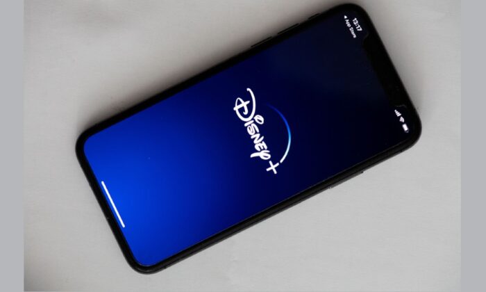 A logo of Disney+ on the screen of a phone in Paris on May 27, 2020. (Martin Bureau/AFP via Getty Images) 