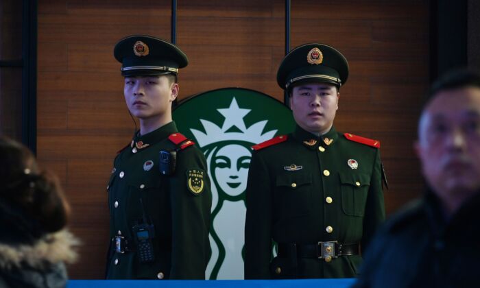 Paramilitary police officers stand guard near a Starbucks coffee shop in Beijing, on Feb. 2, 2019. (Greg Baker/AFP via Getty Images)
