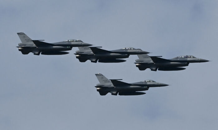 Four upgraded US-made F-16 V fighters fly during a demonstration at a ceremony at the Chiayi Air Force in southern Taiwan on Nov. 18, 2021. (Sam Yeh/AFP via Getty Images)