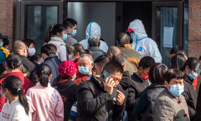 People wait to undergo nucleic acid tests for the Covid-19 coronavirus during a mass testing in Ningbo, in eastern China's Zhejiang province on Dec. 7, 2021. (STR/AFP via Getty Images)