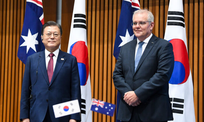 South Korean President Moon Jae-in and Australian Prime Minister Scott Morrison witness a signing ceremony at Parliament House in Canberra, Australia, on Dec. 13, 2021. (Lukas Coch - Pool/Getty Images)