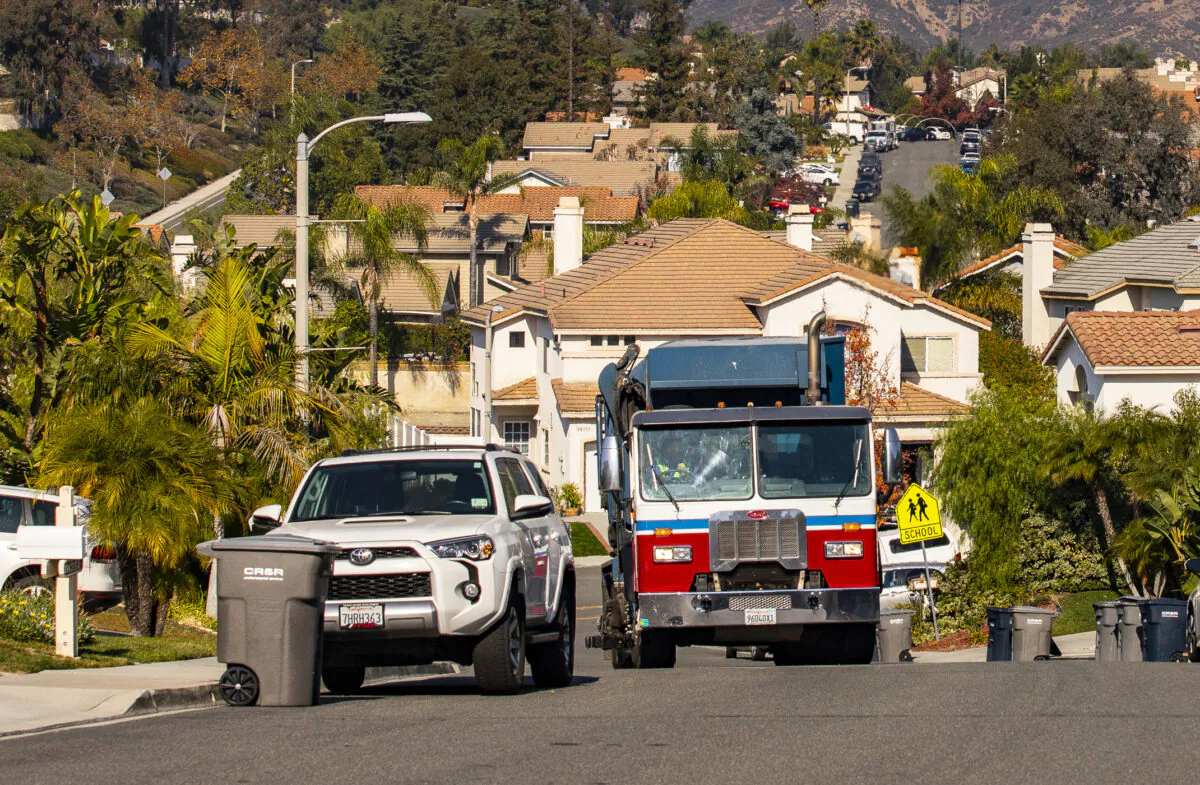A truck gathers and disposes garbage in Lake Forest, Calif., on Dec. 3, 2021. (John Fredricks/The Epoch Times)