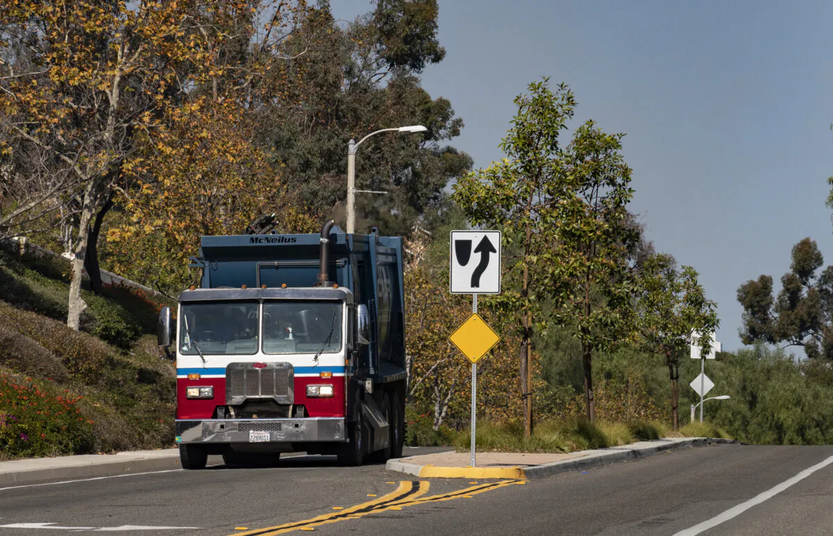A truck gathers and disposes garbage in Lake Forest, Calif., on Dec. 3, 2021. (John Fredricks/The Epoch Times)