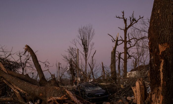 A destroyed vehicle sits in the aftermath of a tornado in Mayfield, Ky, on Dec. 13, 2021. (Adrees Latif/Reuters)