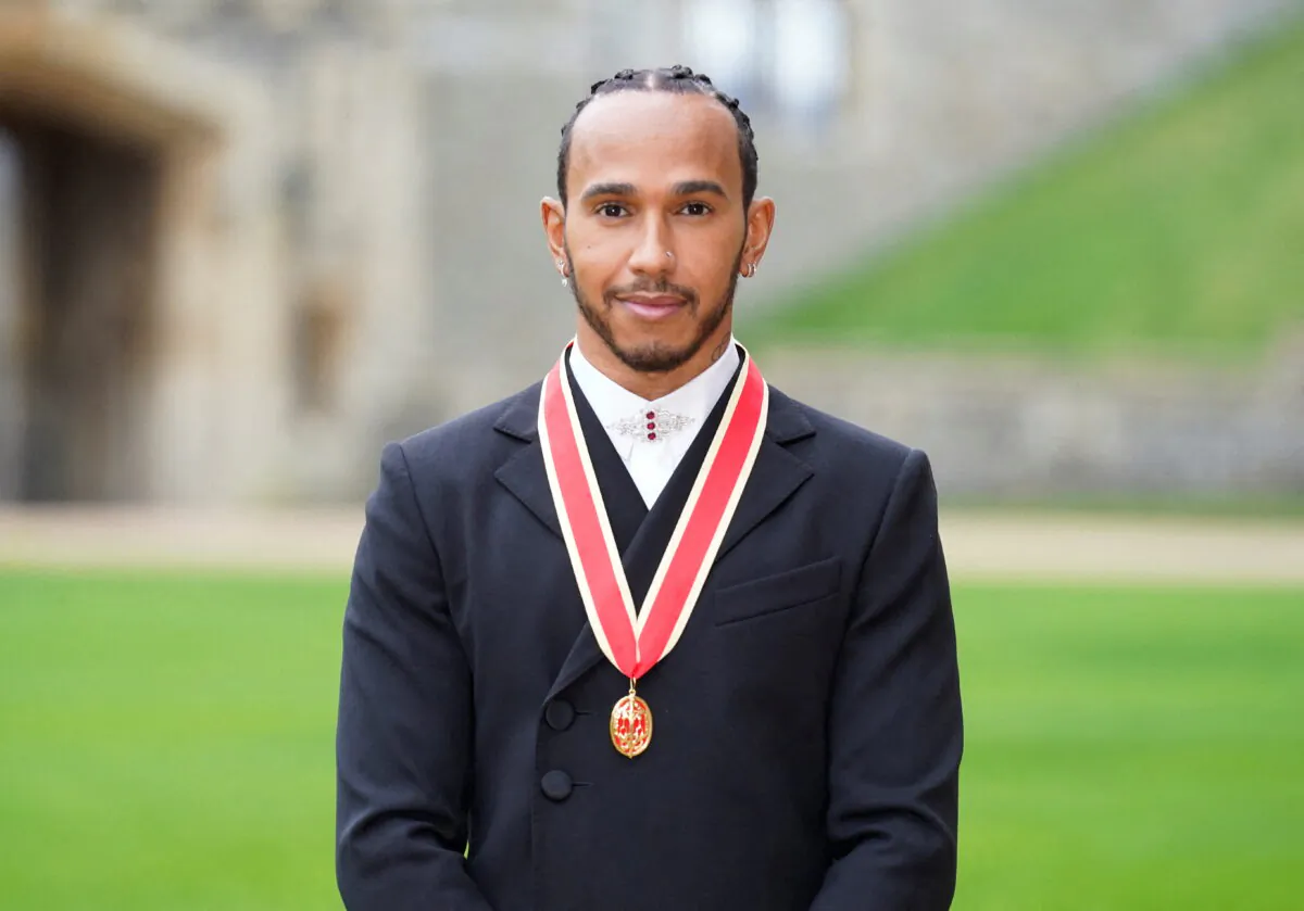 Lewis Hamilton poses for a photo after he was made a Knight Bachelor during an investiture ceremony at Windsor Castle in Windsor, Britain, on Dec. 15, 2021. (Andrew Matthews/Pool via Reuters)